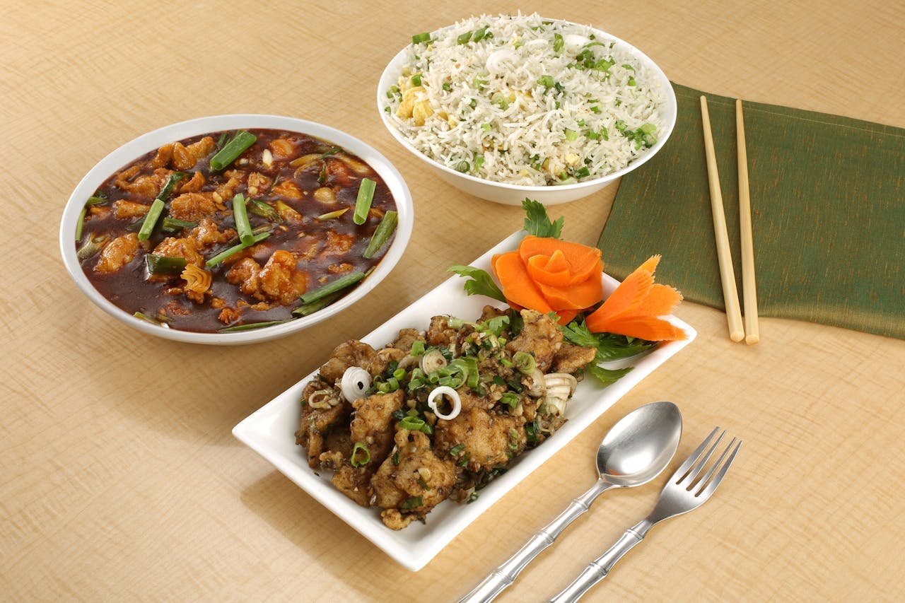 Savor a mouthwatering spread of Asian dishes featuring fried rice and flavorful chicken.
