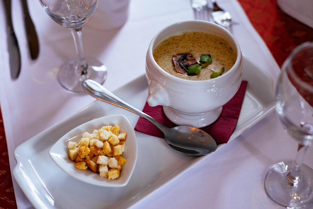 Elegant dish of mushroom soup paired with crunchy croutons, perfect for a gourmet meal.